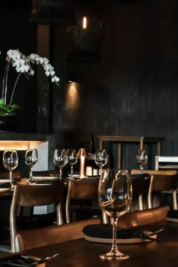 Our elegant table setting, ready for sushi cocktails and fine wines elegant wooden table set with wine glasses at Billy Ho modern Japanese restaurant in Canggu