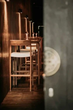 Step through our intimate bar walkway, where sushi cocktails await narrow bar walkway with high stools at Billy Ho modern Japanese restaurant in Canggu