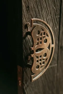 Close-up of our ornate brass door latch, welcoming you into Billy Ho’s modern Japanese dining room ornate brass door latch detail at Billy Ho modern Japanese restaurant in Canggu